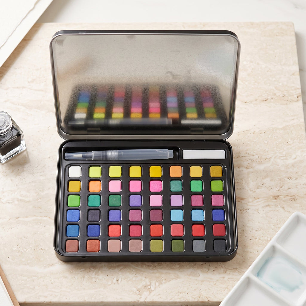 Solid watercolor paint palette in metal storage box