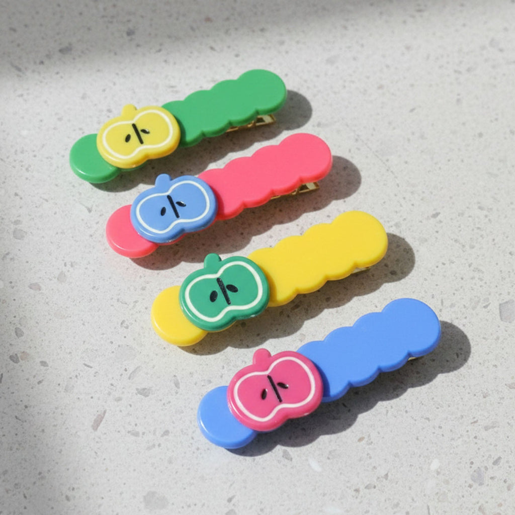 Four apple hair clips arranged to show design and color variety hair accessories