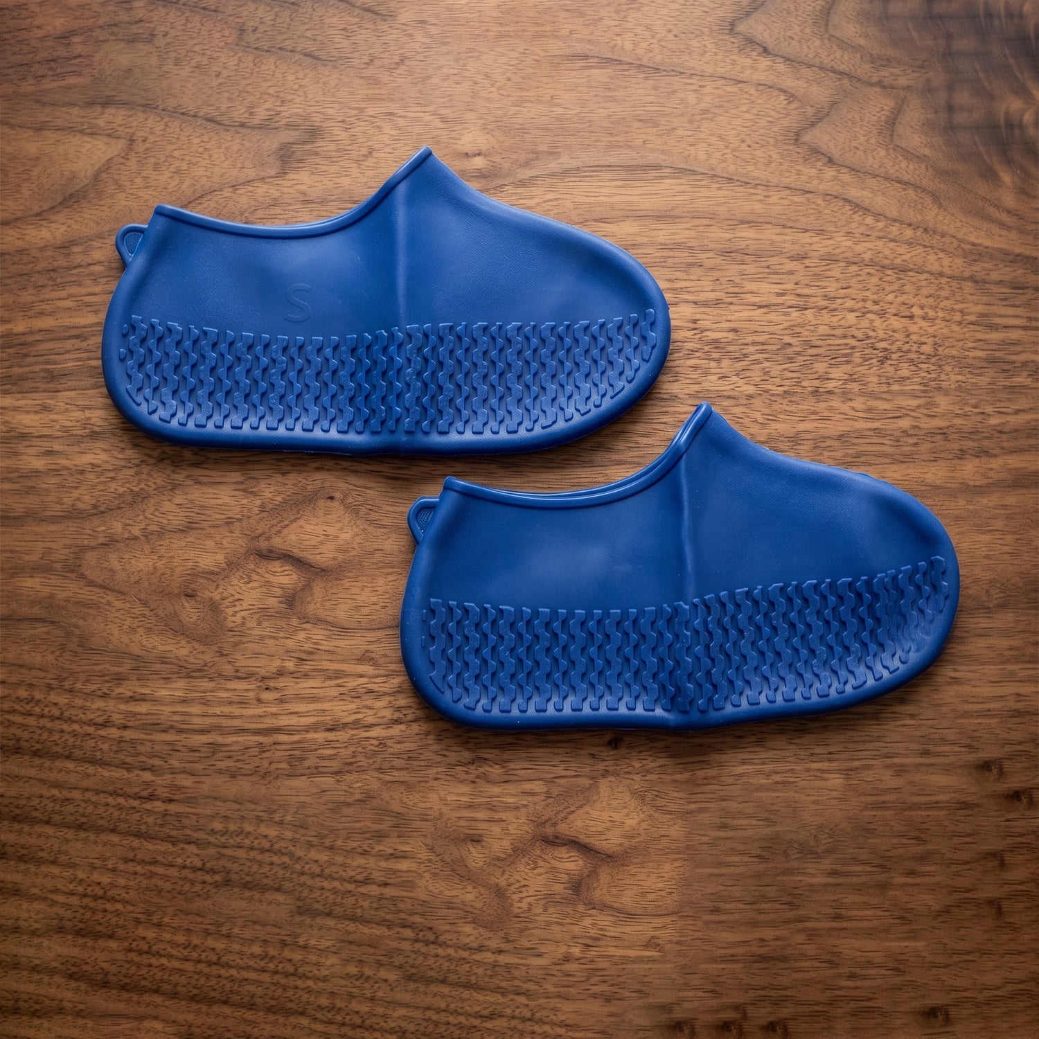 Blue silicone rain shoe cover on white background