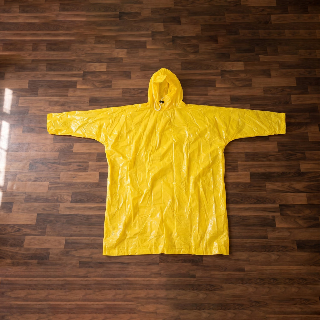 Folded yellow hooded rain poncho, highlighting its portability and compact size.