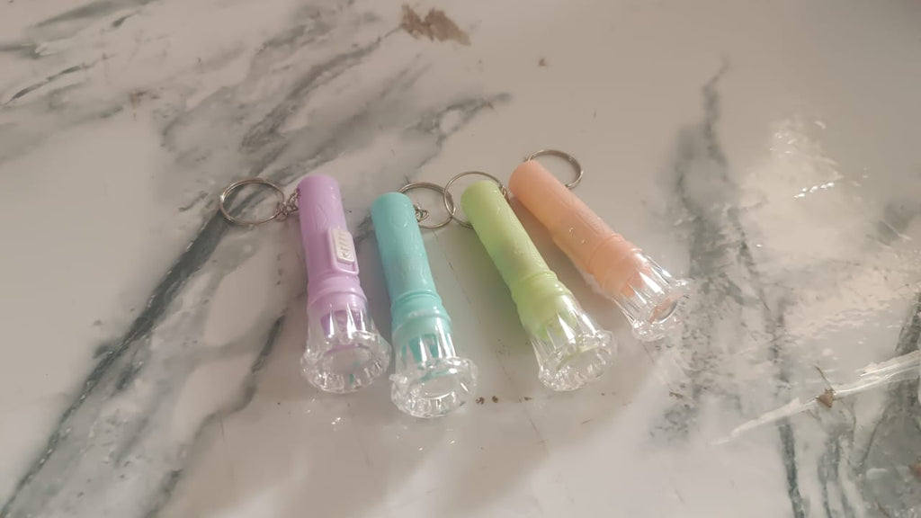 Close-up view of Mini LED Keychain Torch showing LED bulb and switch button